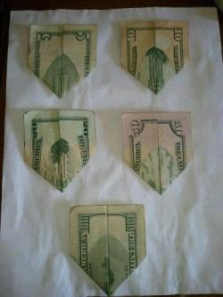 heyh8r:  If looked at closely , the five dollar bill represents the twin towers, the ten is after the planes collided, the twenty shows a building colapsing, the fifty is the dust and smoke, and the hundred is the buildings completely not there, a new