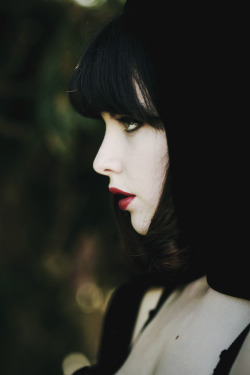 Pale white, raven haired, blood red lips.