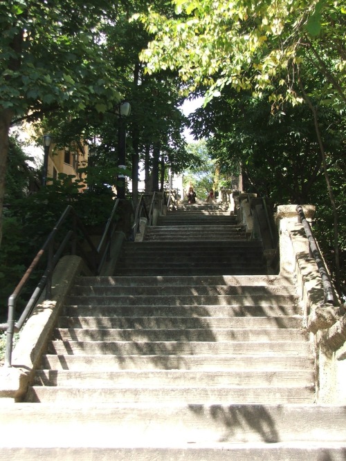 Steps leading down to Broadway on 215th Street highlight the steepness of the terrain of Inwood in U