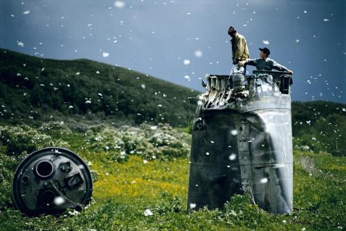 neil-gaiman:RUSSIA. Altai Territory. 2000. Villagers collecting scrap from a crashed spacecraft, sur