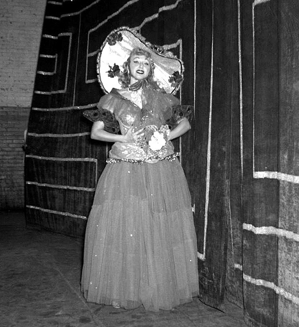   Lynne O’Neill poses backstage in full dance costume, at an unidentified Burlesk