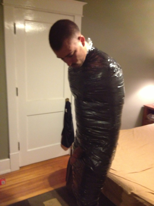 bondageman007:  It had been a wild night for Kenny. He woke up with a pounding headache. It wasn’t until he tried to get up that he noticed that his douche bag frat brothers had mummified him in several tight layers of duct tape. He noticed his dick