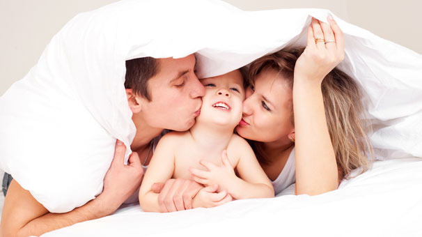 Couple sleeping under blanket