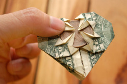 How to fold a dollar into the shape of a heart with a coin embedded.