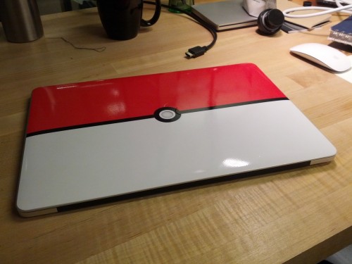 sardonicheight:  So I made a custom Pokéball skin for my MacBook Pro. I lined everything up and manually cut the circle out of the middle. Now, when you open the laptop (and the backlight is on), the circle glows. I’m pretty happy with it. ^^ 