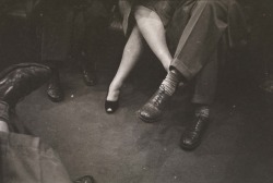  Couple playing footsies on a subway. 1946.