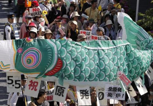 Participants hold a traditional Koinobori carp-shaped banner during a march welcoming the shut down of the nation’s last nuclear reactor in Tokyo on Saturday. (May, 2012)
Resources: Reconsidering Dependency — In addition to this, the tsunami caused a...