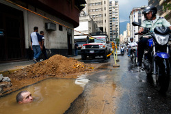 inothernews:  bobbycaputo:  A worker is seen partially submerged under water as he tries to repair a broken pipe in Caracas, Venezuela, on Sept. 26. (Rodrigo Abd/Associated Press)  Some of the best photojournalism is that which illustrates the surreality