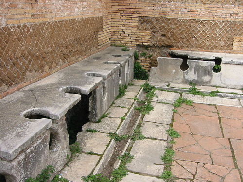 Ancient Roman Public Toilets,A simple row of toilets.  Waste was carried away by constantly flowing 