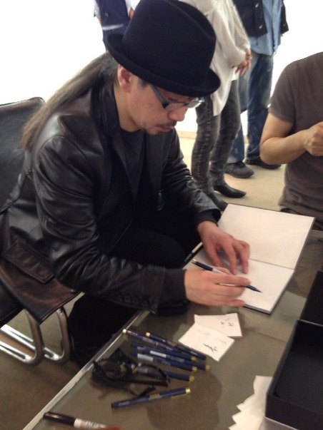 Takato Yamamotosigning new booksat Osaka exhibition