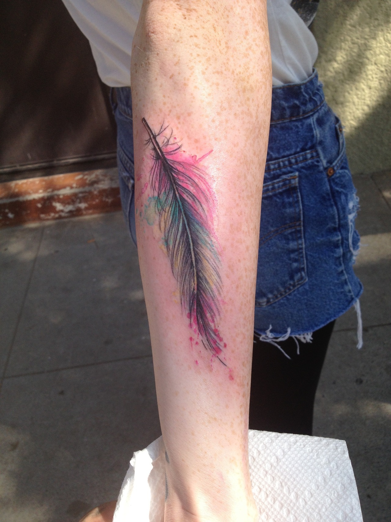 fuckyeahtattoos:  My watercolor feather on my outer forearm. :D Greg Sumii at Liquid