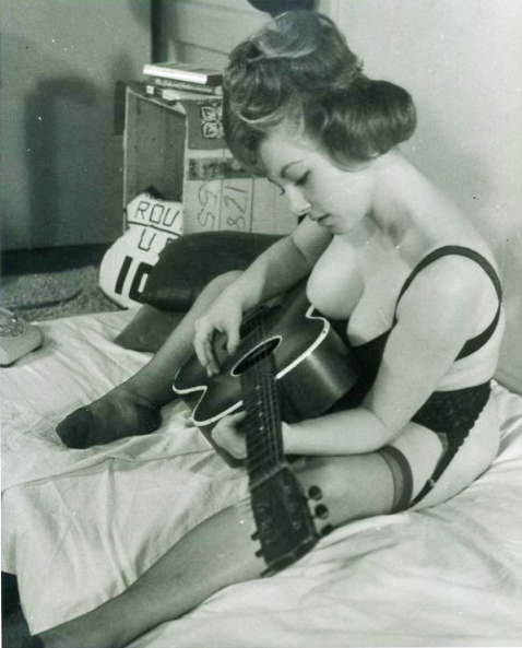 the60sbazaar:  Sixties pin up girl strums her guitar  