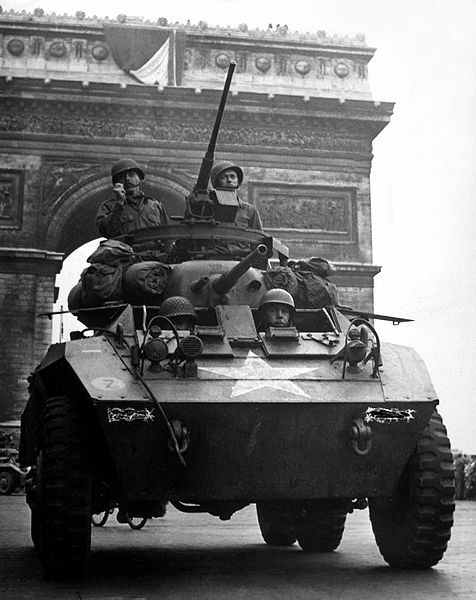 collective-history:An M-8 “Greyhound” armored scout car of the US Army passes under the Arc de Triom