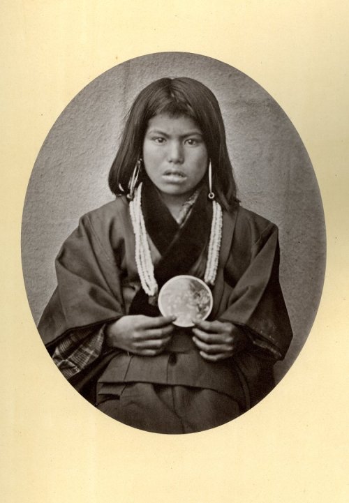 Photograph (black and white); front view of an Ainu woman [live in northern Japanese island] ; weari