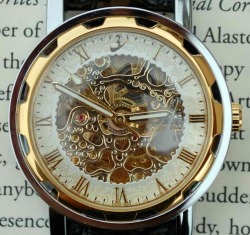 the-absolute-funniest-posts:  This timepiece is all about understated luxury. The soft, ivory face provides a clean-cut look of elegance, all accented in gold. The center of this piece is exposed to reveal its mechanical inner-workings. This watch is