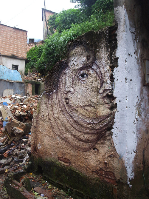 superawesomeshop:  Since 1997 Brazilian artist Andre Muniz Gonzaga has been turning haphazard, porous, or cracked surfaces into bizarre, misshapen faces in his unique style of street art portraiture. His site-specific paintings have appeared around the