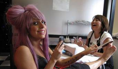 hernameisstefani:  Can we all just take a moment to appreciate this pic of Gaga being a cute dork, filing away those bunions from her fab heels while that woman laughs like a psycho in the background? 