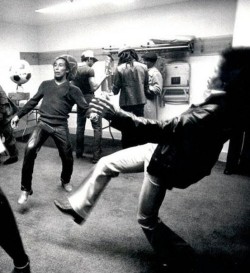    Bob Marley and Jimi Hendrix volley a soccerball.