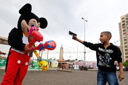 politics-war:  A Syrian refugee boy points