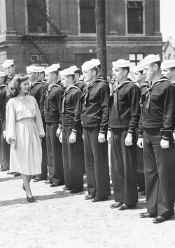 jeanarthur:  Paulette Goddard reviews a line of sailors during a visit to a Navy Yard, 1940 