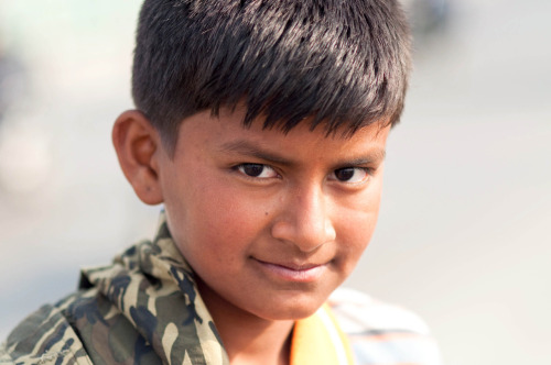 A street boy on the Bagmati Bridge near his slum home in Kupondole, Nepal. Photography by BrookR