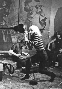 updownsmilefrown:  Chris Stein and Debbie Harry of Blondie with roadie, Michael Sticca, CBGB, New York City, 1977 by Justin Borucki  I love this woman.