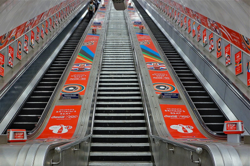 Escalators at Hyde Park Corner Tube Station showing London 2012 sponsorship