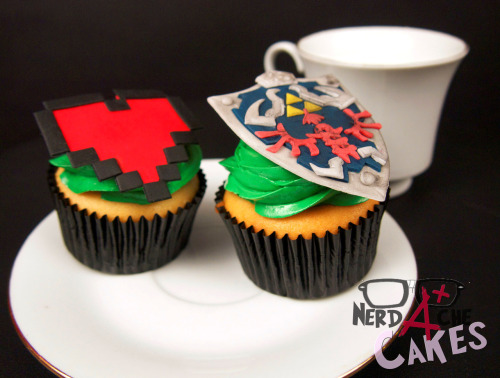 nerdache-cakes:  Legend of Zelda Cupcakes! I found these super quality photos of these cupcakes I did a while back, so I thought I’d share. 8 bit hearts are my weakness ok. They are so cute. Also, come on. Link’s shield? You know I live for detailed