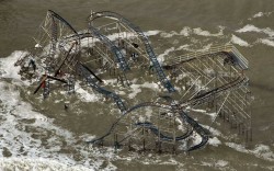 A destroyed roller coaster rides the surf