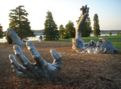 mydarkenedeyes:  J. Seward Johnson - The Awakening (1980) The Awakening is a 70ft statue of a giant embedded in the earth, originally installed at Hains Point, Washington, D.C. The statue consists of five separate aluminum pieces buried in the ground,