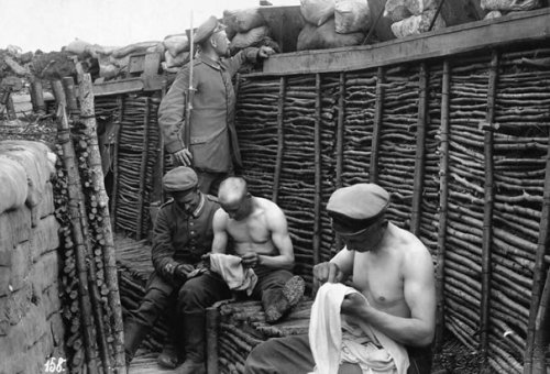 German soldiers picking lice from their clothes, World War I.