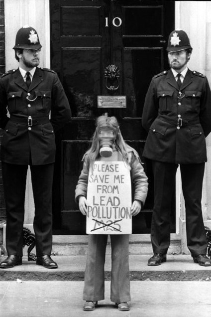 9 year old Rachel Geary stands outside No 10 Downing St. wearing a gas mask and holding