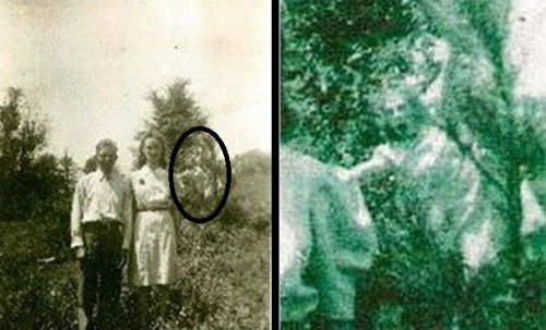 stonedpervert:     ghostghoul:  Ghost Picture of the Day: The Thing in the Trees Someone’s not happy with the couple in the picture… The story behind this pic, taken in Jasper, Alabama in 1942, is that the man and woman had just gotten married, and