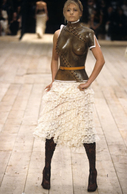 santullianal:  Alexander McQueen SS 1999  “They were solid wood, solid ash, so there’s no give in the ankle. So any kind of a runway walk that I had practiced went out the window. And then suddenly they laced me into this leather bodice, and there