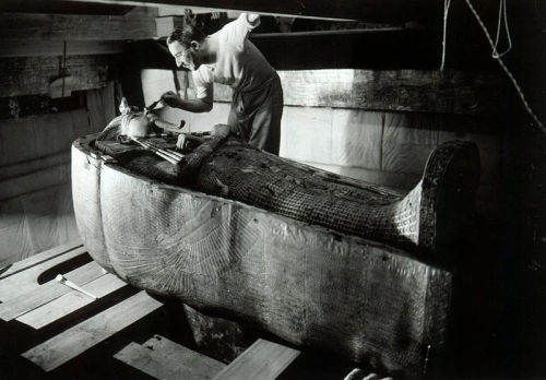 Howard Carter in the Tutankhamen’s tomb, dusting off the final Sarcophagus. 1924