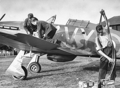 worldwar-two:Three armorers, called ‘plumbers,’ reload Hurricane’s eight machine guns with ammunitio