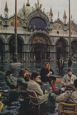  When a November storm strikes, water smothers the Piazza San Marco… At a sidewalk café, students take the calamity in their stride. Photographed by Albert Molday National Geographic, 1972 