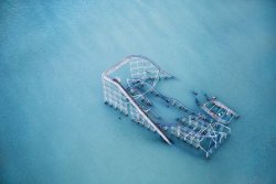 inspirezme:  Seaside Heights, N.J.: The Star Jet roller coaster at Casino Pier amusement park, once a Jersey Shore landmark, remains partly submerged in the Atlantic [ images © Stephen Wilkes for TIME ]  