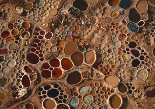 Saltwater Pools, Niger Photograph by George Steinmetz Laborers collect salt from pools of evaporatin