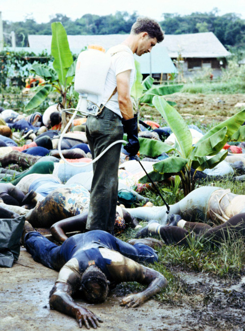 thats-the-way-it-was: November 20, 1978: Jonestown, Guyana - A member of the US Army sprays disinfec