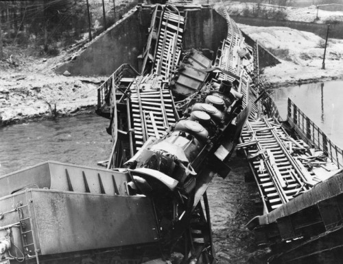 demons:A destroyed railroad bridge at the Moselle River in Germany, 1945