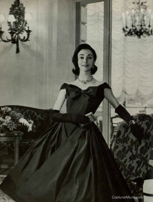 The Nifty Fifties — Model wearing a black silk faille party dress by...