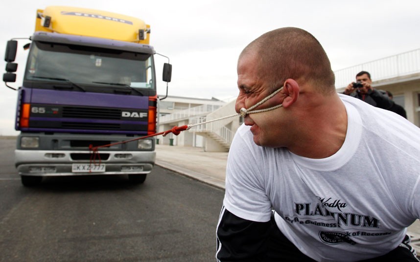Can you hear me now? (Lasha Pataraia of Russia pulls an 8-ton truck lashed to his