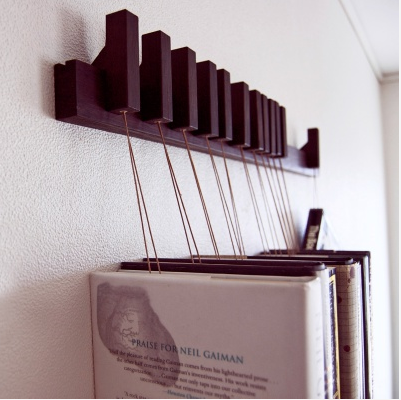    The book rack comes in solid Wenge, with a set of 12 pins/bookmarks. The pins