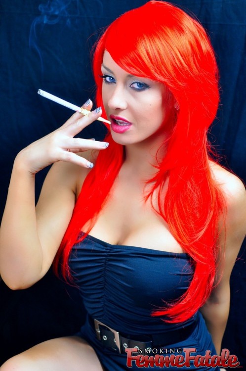 Michelle from www.smokingfemmefatale.com rocking red hair and a cigarette holder.