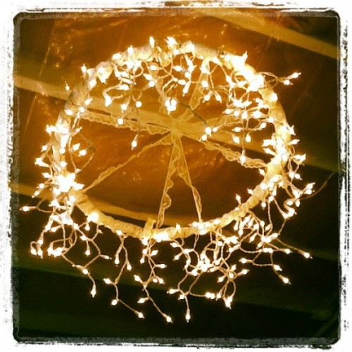 DIY Wedding Lighting Idea: Wrap a hula hoop in lace and string/icicle lights to create a chandelier