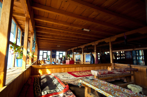 The warm, cozy sitting/dining room at Hotel Red Panda in Sing Gompa, Rasuwa Nepal. Photography by Br