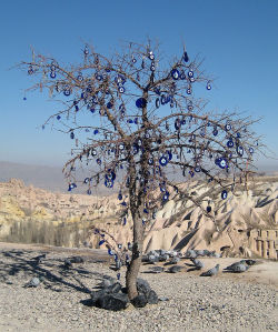 againstagamemnon:  A tree in Turkey, adorned with Nazars; charms designed to ward off the ill effects of the evil eye. 