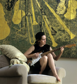 1996:Winona Ryder playing guitar in her apartment