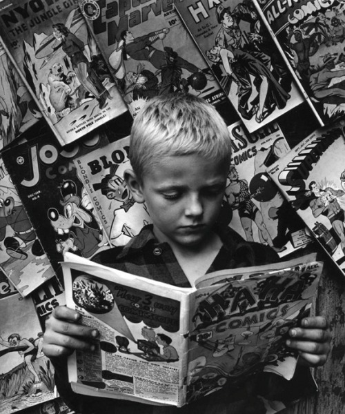 Boy Reading Ha Ha Comic Book. Park Avenue, NYC, 1947. Morris Engel.Engel (1918-2005) was a pioneer i